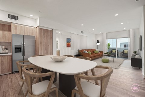 a kitchen and living room with a white table and chairs