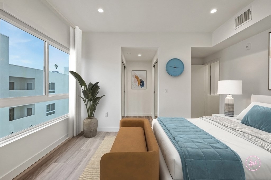 a bedroom with a large bed and a large window