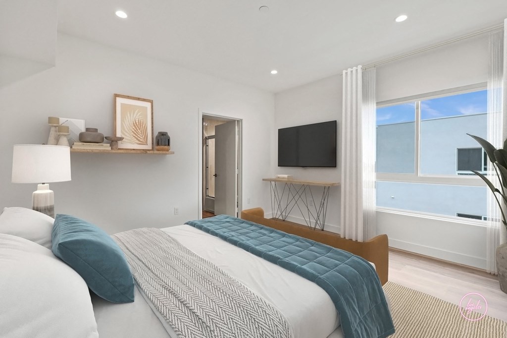 a bedroom with a bed and a large window