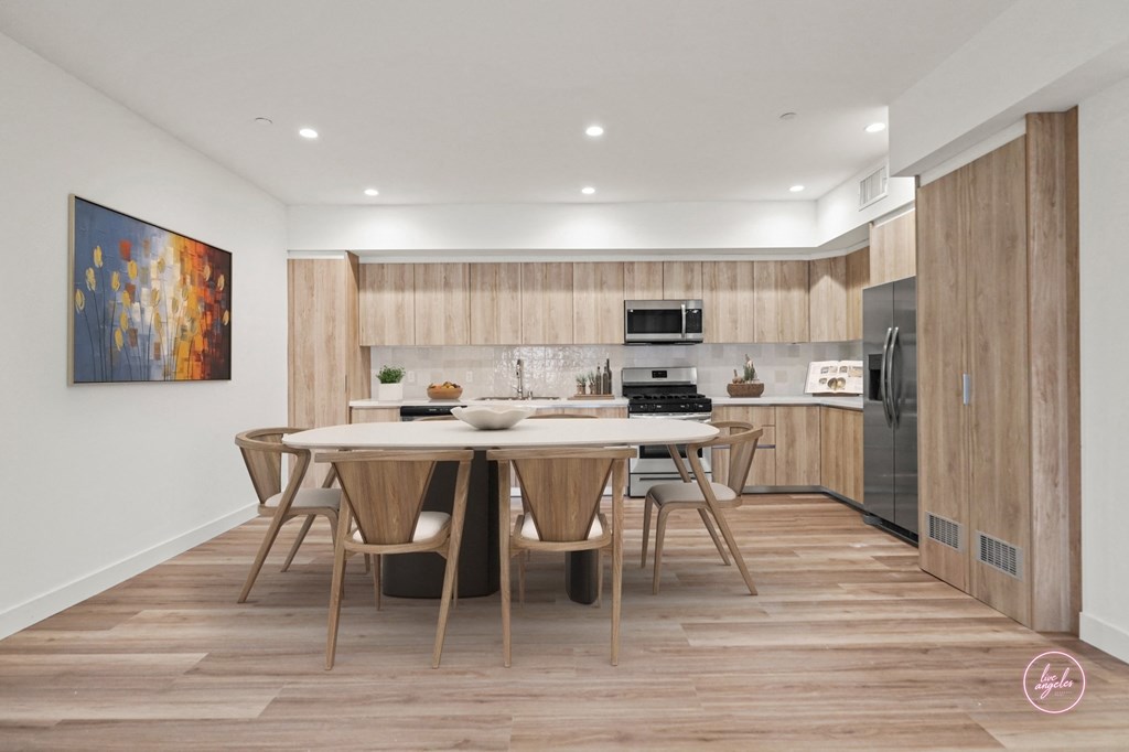 a kitchen and dining area with a table and chairs