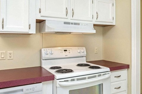 a kitchen with white appliances and white cabinets