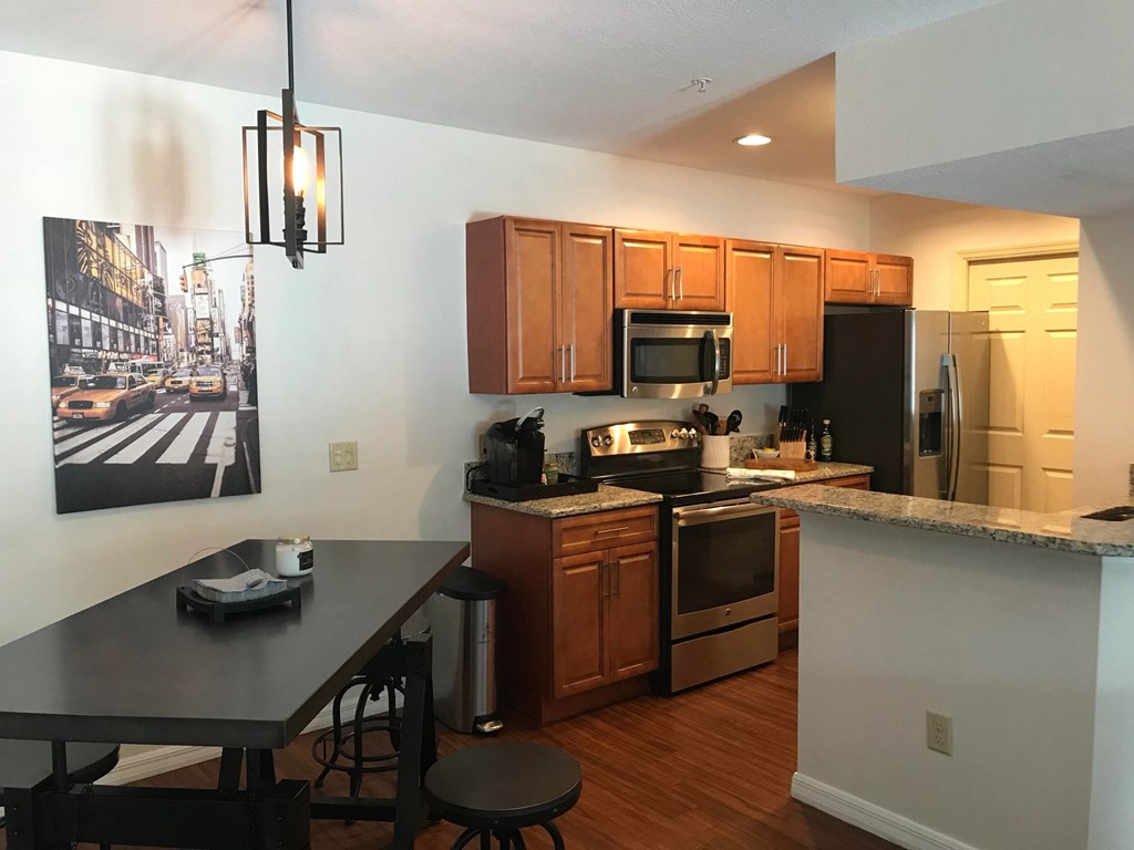 a kitchen with wooden cabinets and stainless steel appliances