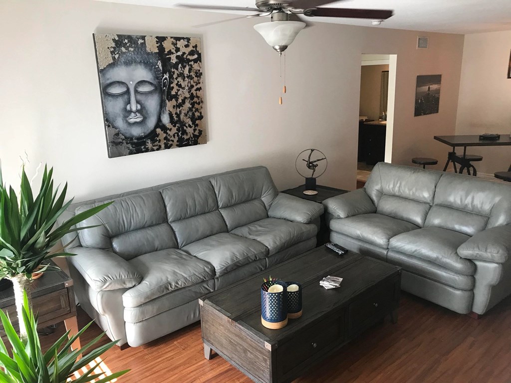 a living room with leather couches and a coffee table