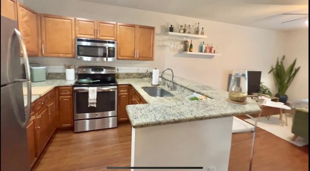 a kitchen with granite counter tops and stainless steel appliances