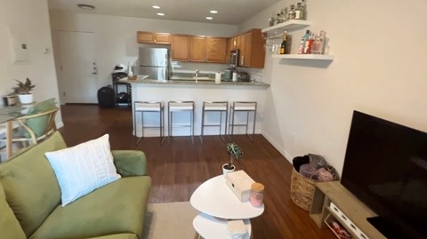 a living room and kitchen with a couch and a table