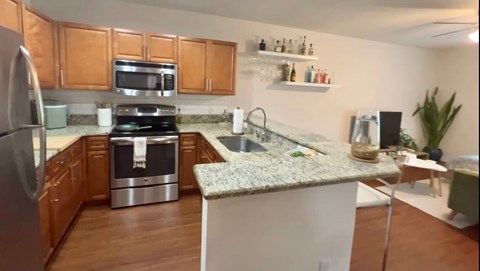 a kitchen with granite counter tops and stainless steel appliances