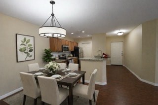 A dining room with a table set for six people.
