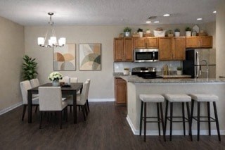 A kitchen with a dining table and chairs.