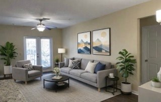 A living room with a grey couch, a coffee table, and a painting on the wall.
