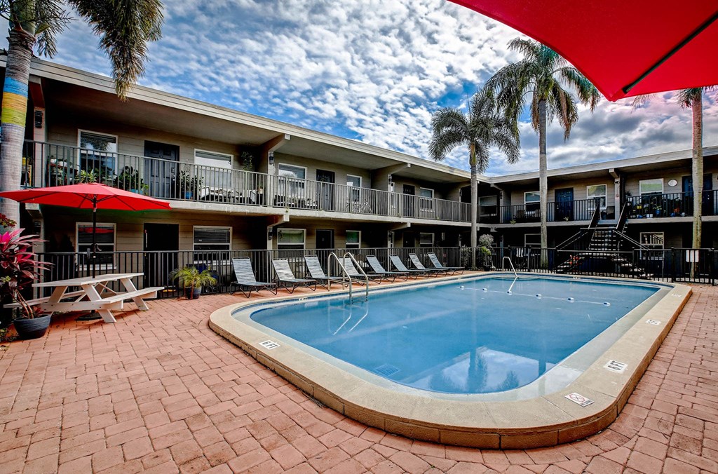 a swimming pool at a hotel with palm trees