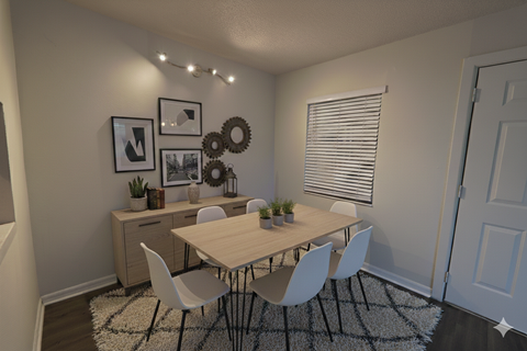A dining room with a wooden table and white chairs.