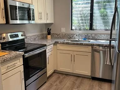 a kitchen with stainless steel appliances and white cabinets