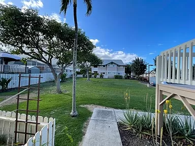 a backyard with a deck and a yard and a house
