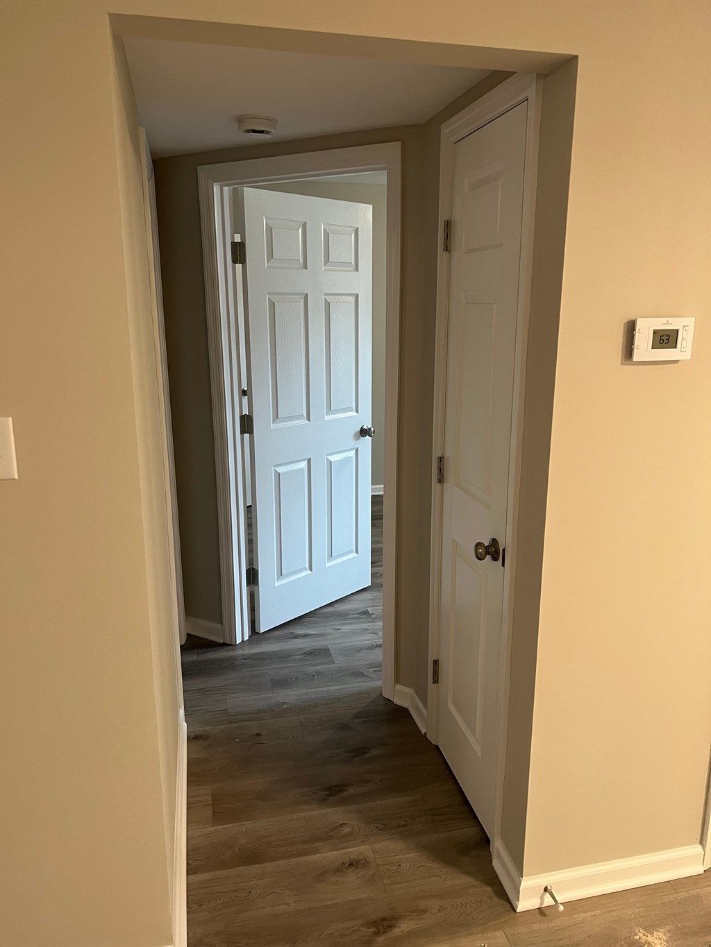 A white door is open to a hallway.