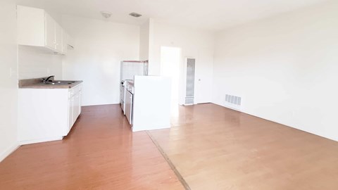A kitchen area with a refrigerator, oven, and sink.