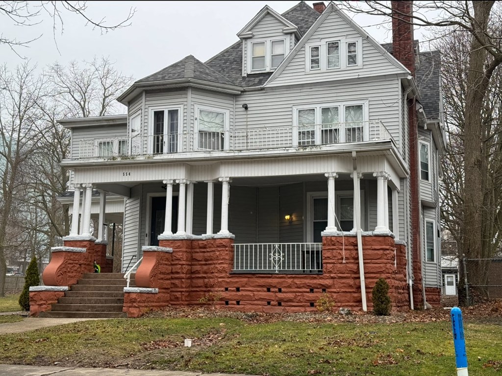 a large white house with columns and a porch