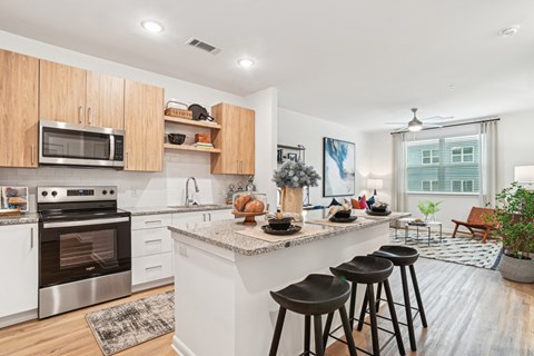 A kitchen with a white counter top and wooden cabinets.