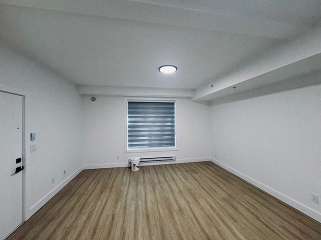 an empty room with white walls and a wooden floor