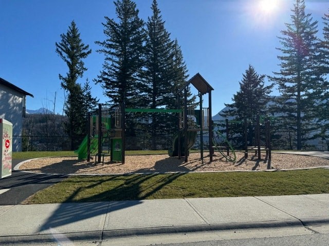 a playground in a park next to a sidewalk