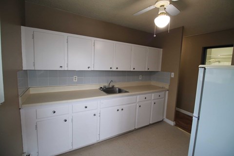 a kitchen with white cabinets and a sink