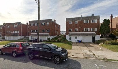 A black car is parked in front of a red car.