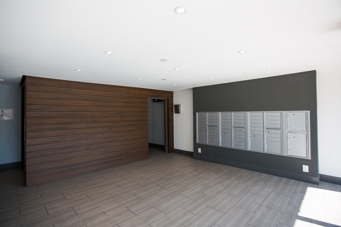 a large room with a wall of mailboxes and a door