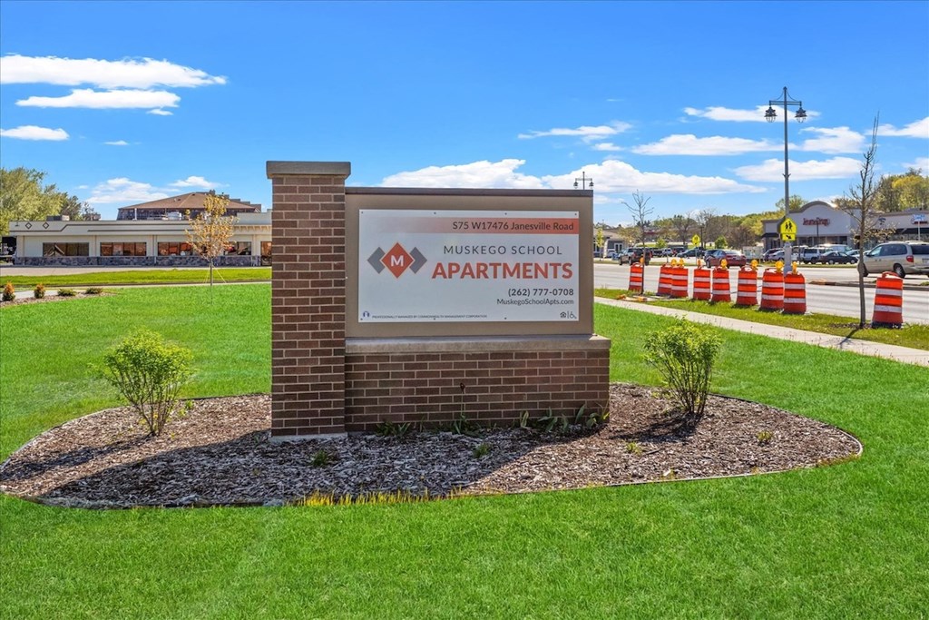 The monument sign beside the road at Muskego School Apartments