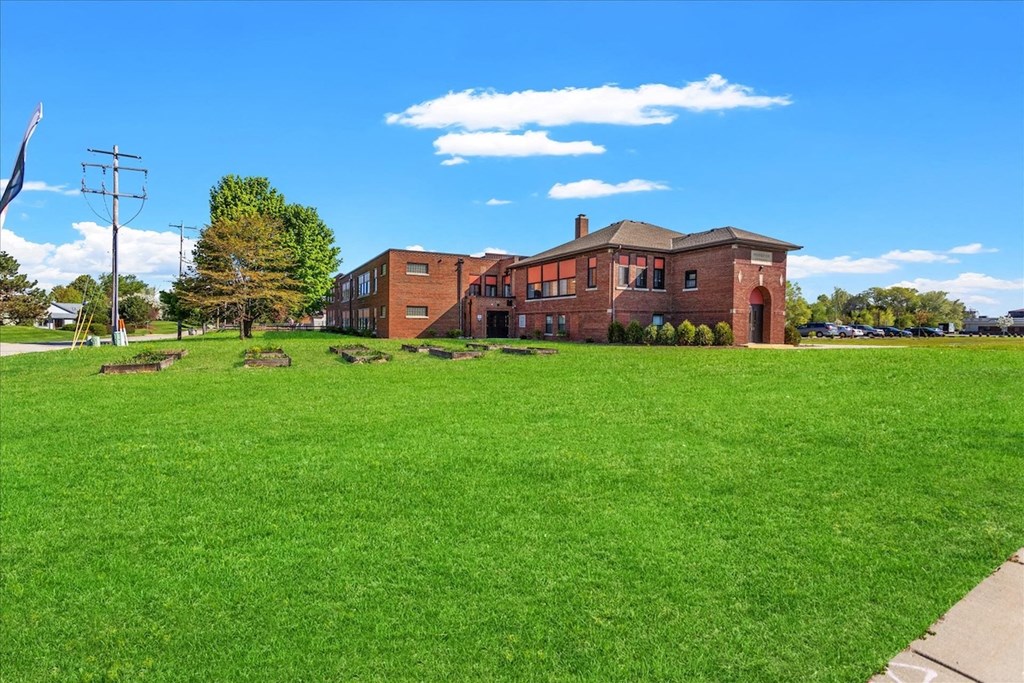 The large green courtyard surrounding Muskego School Apartments