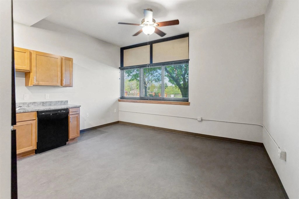 a spacious kitchen with a ceiling fan at Muskego School Apartments in Muskego, WI