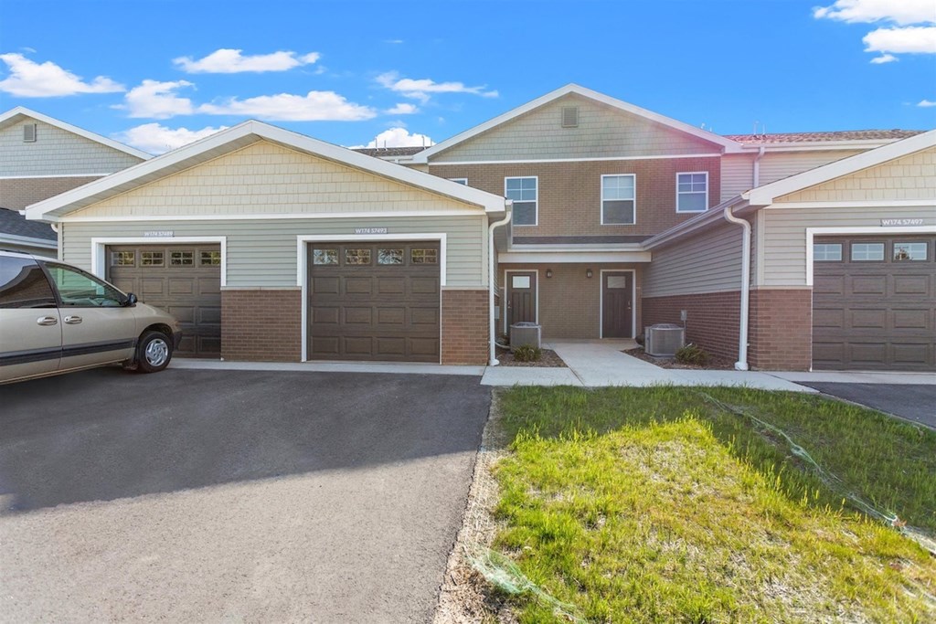 Private driveways and garages at Muskego School Apartments in Muskego, WI