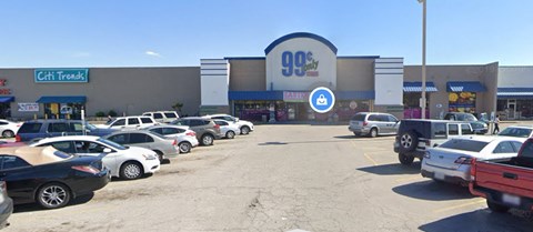 a parking lot full of cars in front of a grocery store