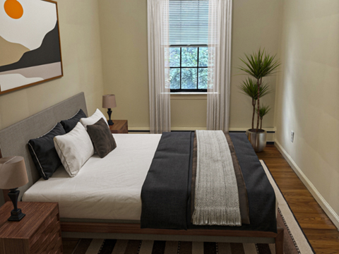 A bedroom with a large bed and a painting on the wall.
