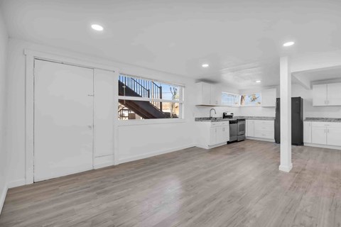 A spacious kitchen with white cabinets and a large island.