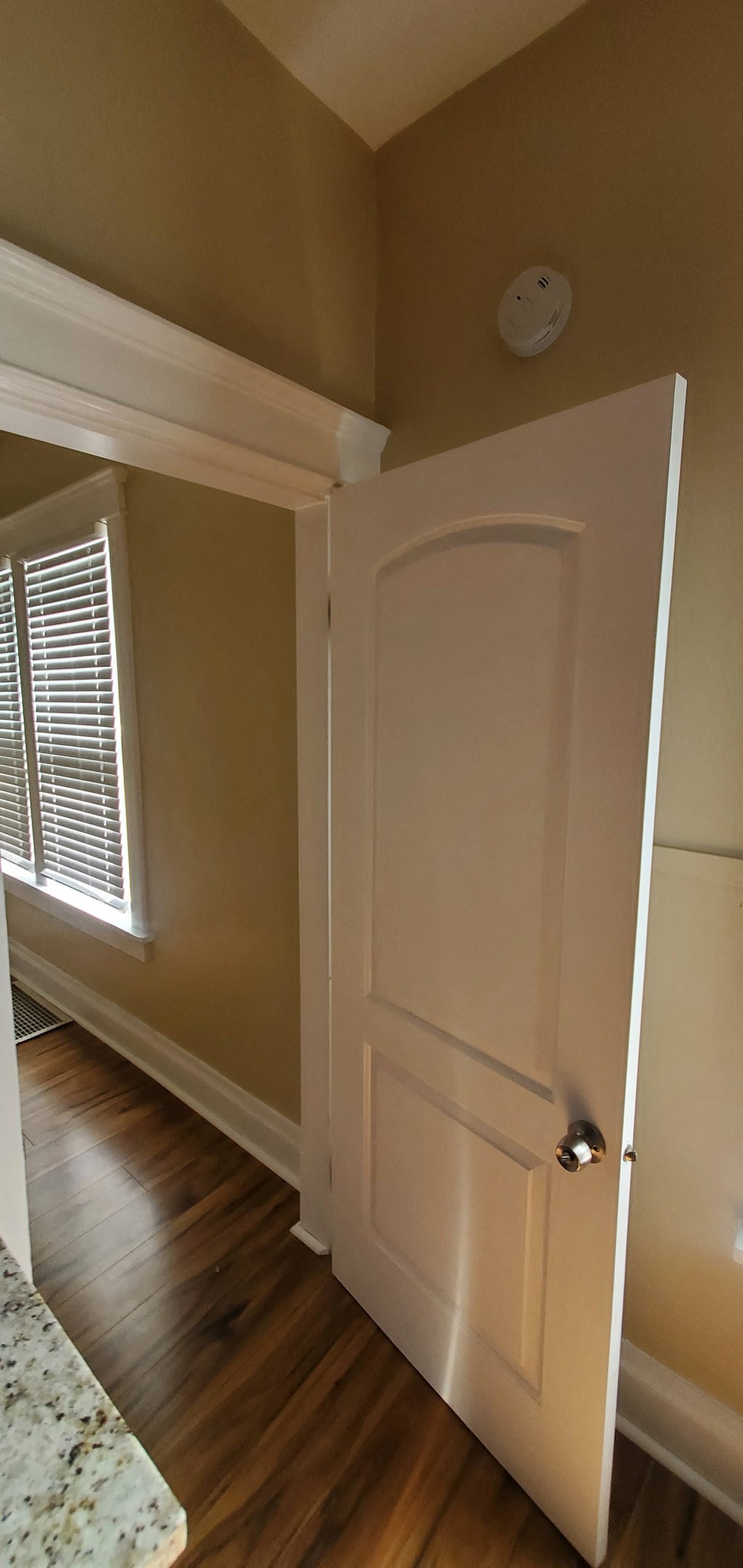 the door to the dining room is open to the hallway and the window is open