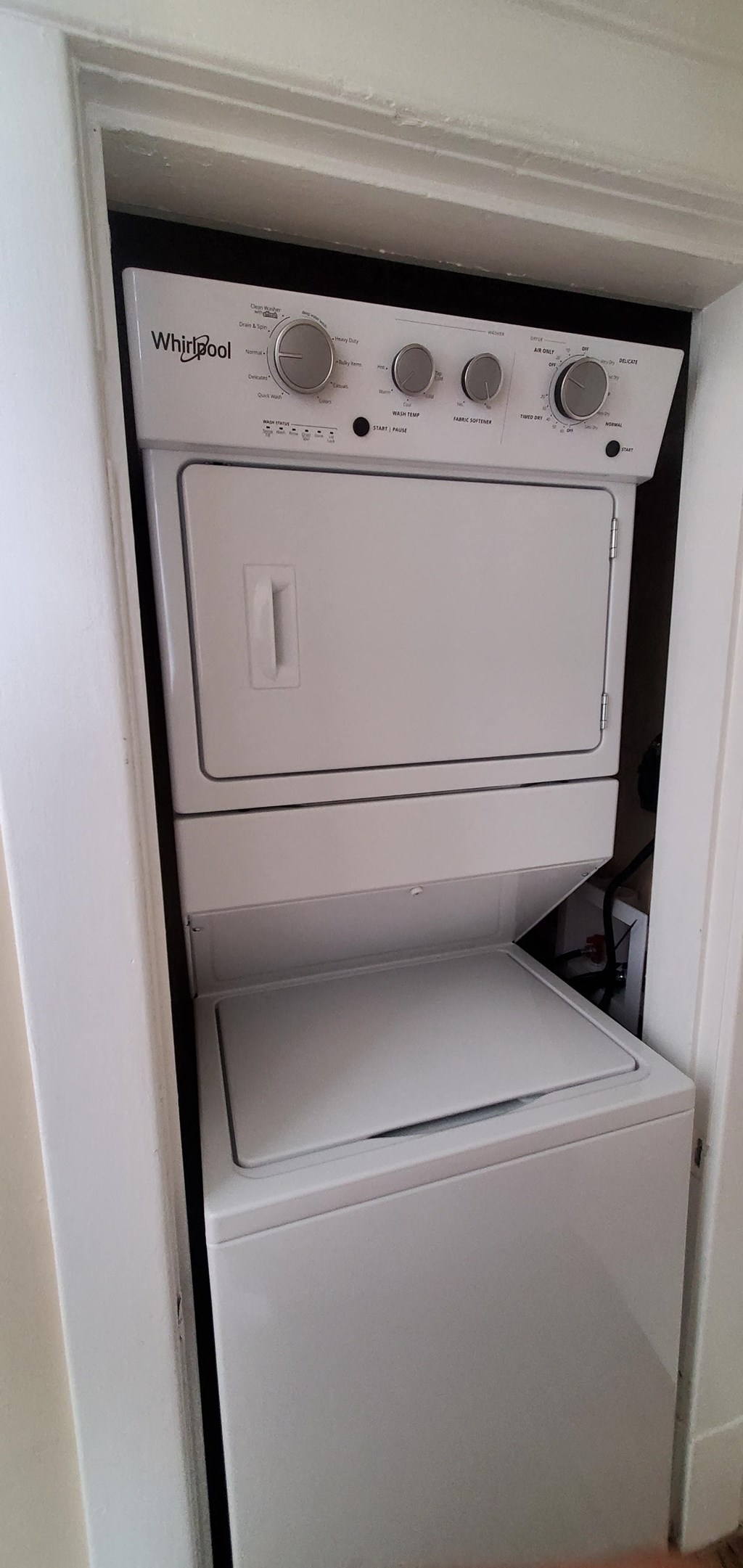 the dishwasher is in the closet next to the washer and dryer