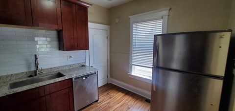 a kitchen with a sink and a refrigerator