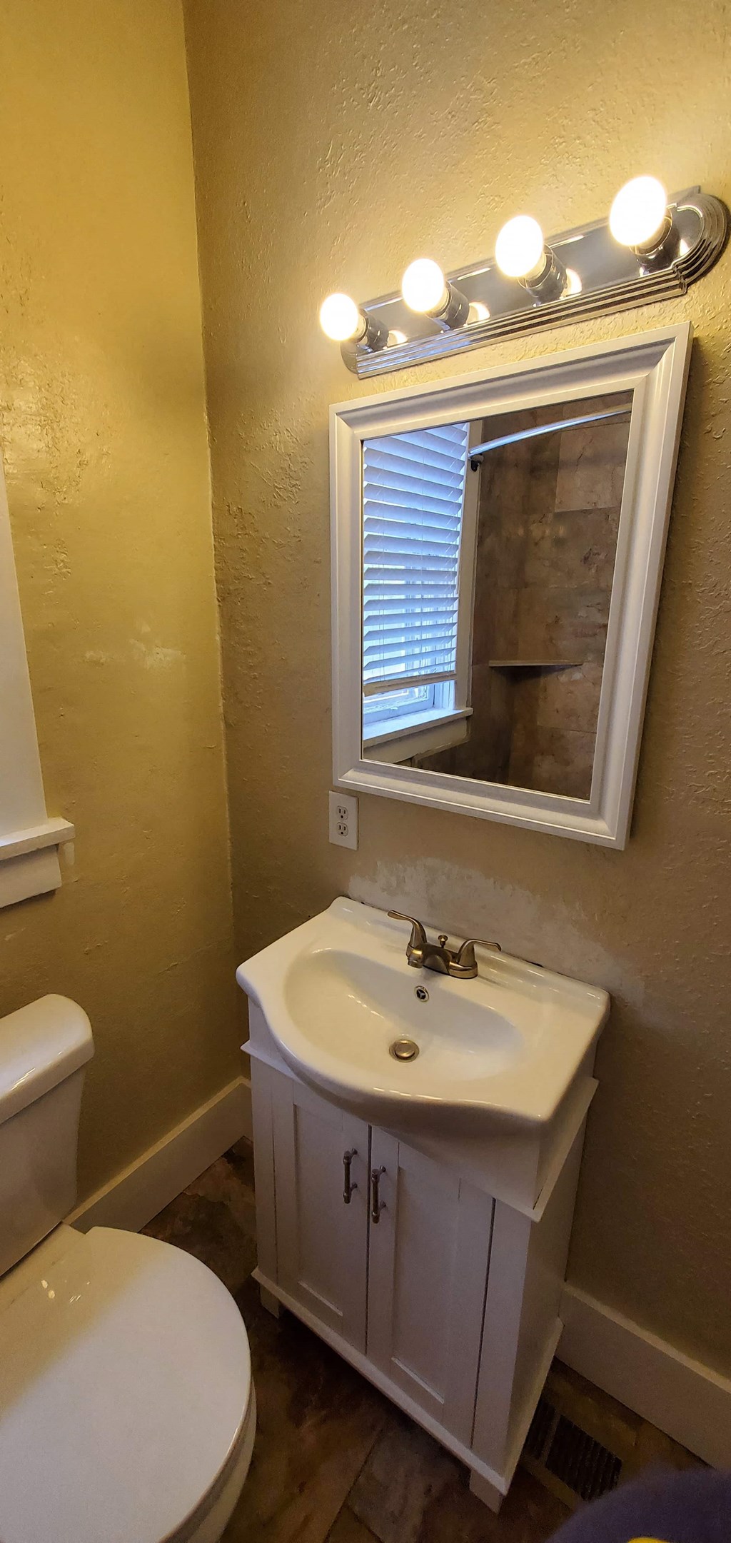 a bathroom with a sink and a mirror