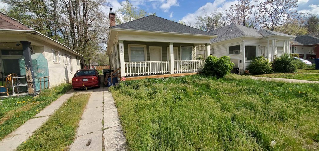 a house with a red car parked in front of it