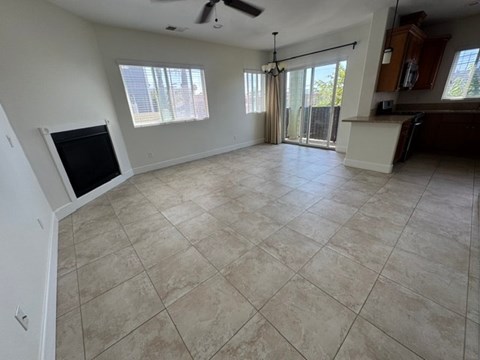 A living room with a television and sliding glass doors.