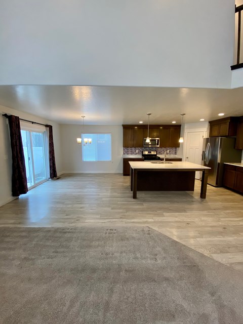 A spacious kitchen with a dining table and chairs.