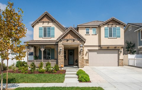 a house with a garage door in front of it