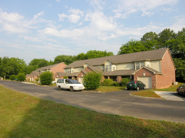 a neighborhood of houses with cars parked on the street