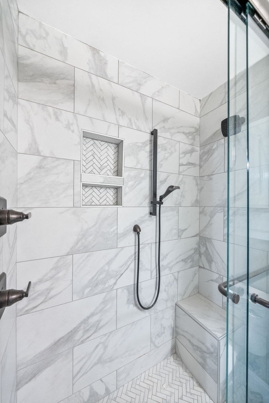 the master bathroom has a large shower with a glass door
