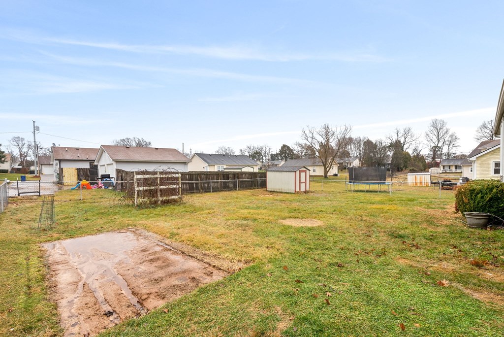 the backyard of a house with a fenced in yard and a playground