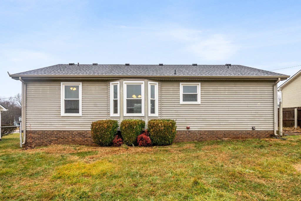 a small house with a yard in front of it