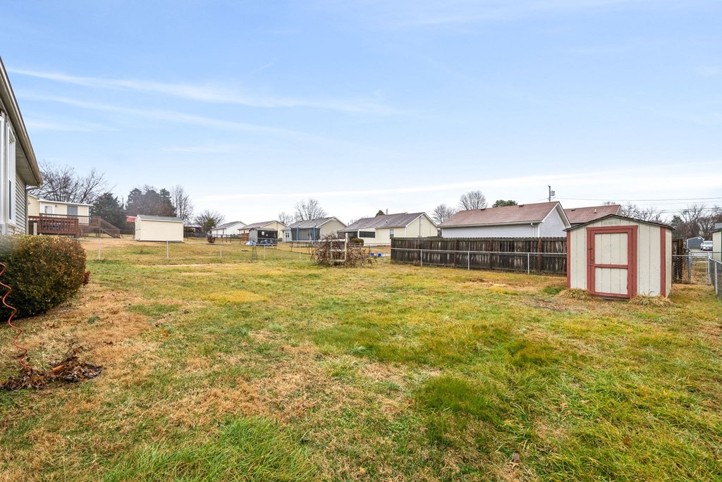 a group of sheds in a field in front of houses