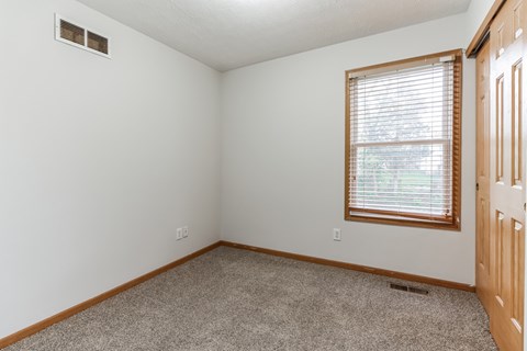 an empty room with a window and a door