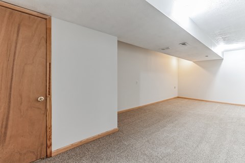 an empty room with a wooden door in the middle of it