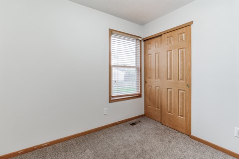 an empty room with a door and a window