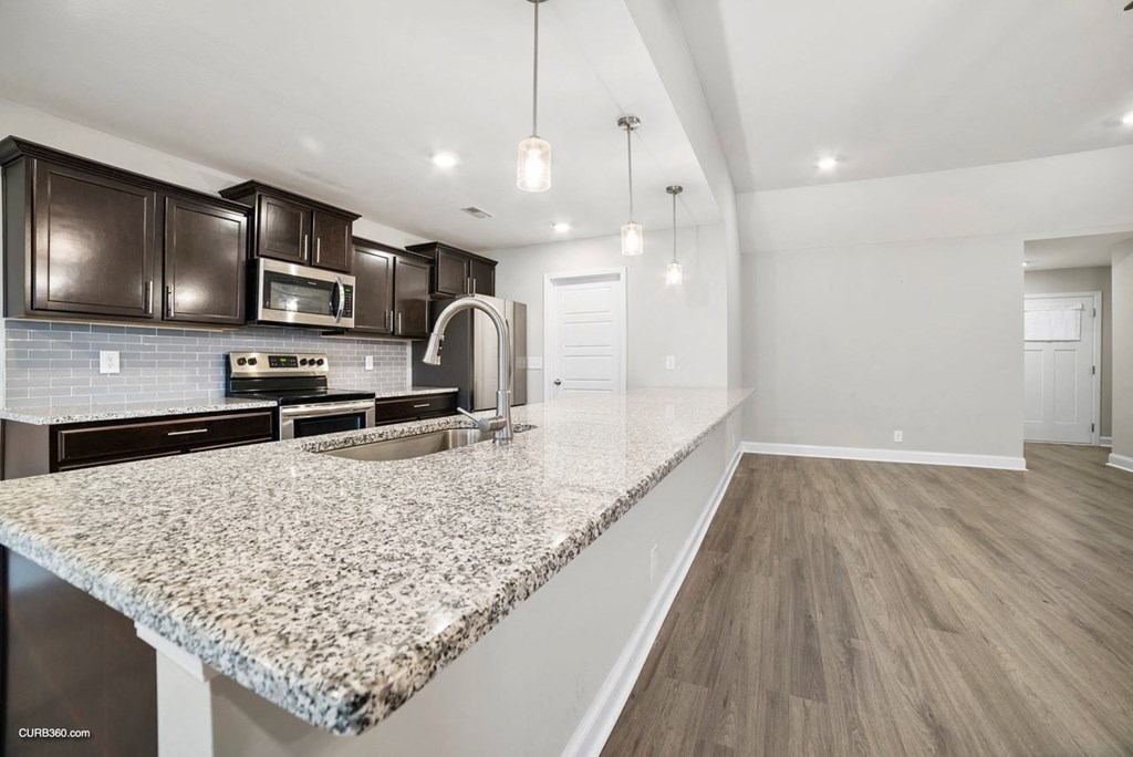 a kitchen with a granite counter top and a sink